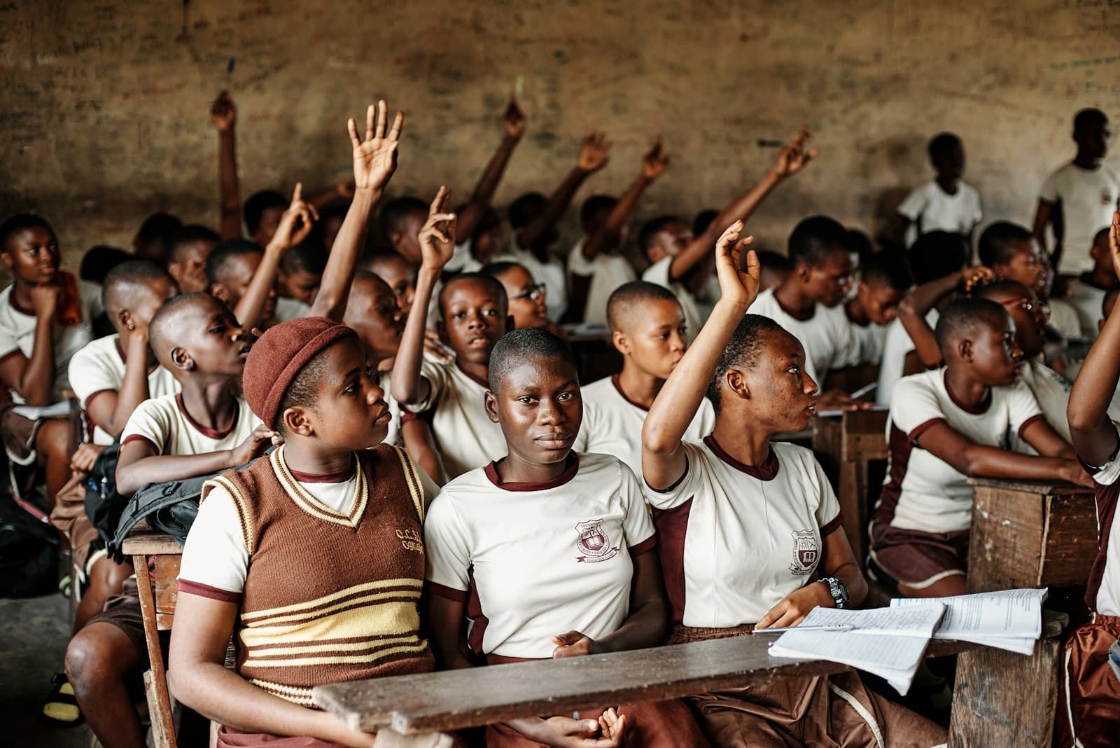 Students raising their hands in class